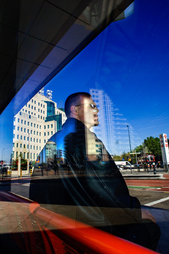 Photo of man sitting at Vauxhall Cross bus station, London, England